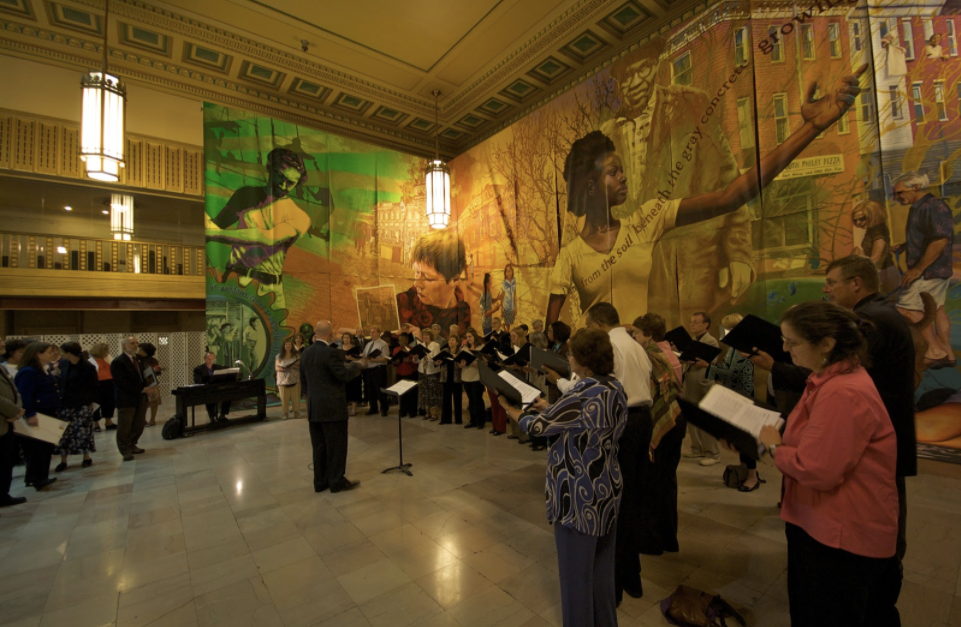 A large mural in a hall with yellow and green colors.