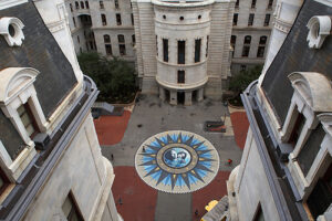 Aerial view of a courtyard with a large compass design